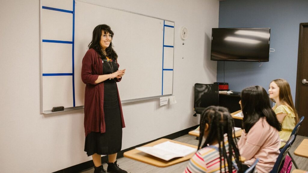 A teacher conducts a lesson with attentive diverse students in a modern classroom setting.