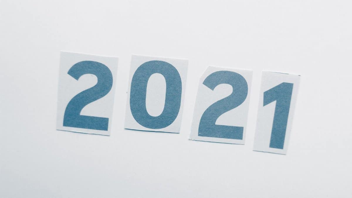 Simple paper cutout showing the year 2021 on a plain background.