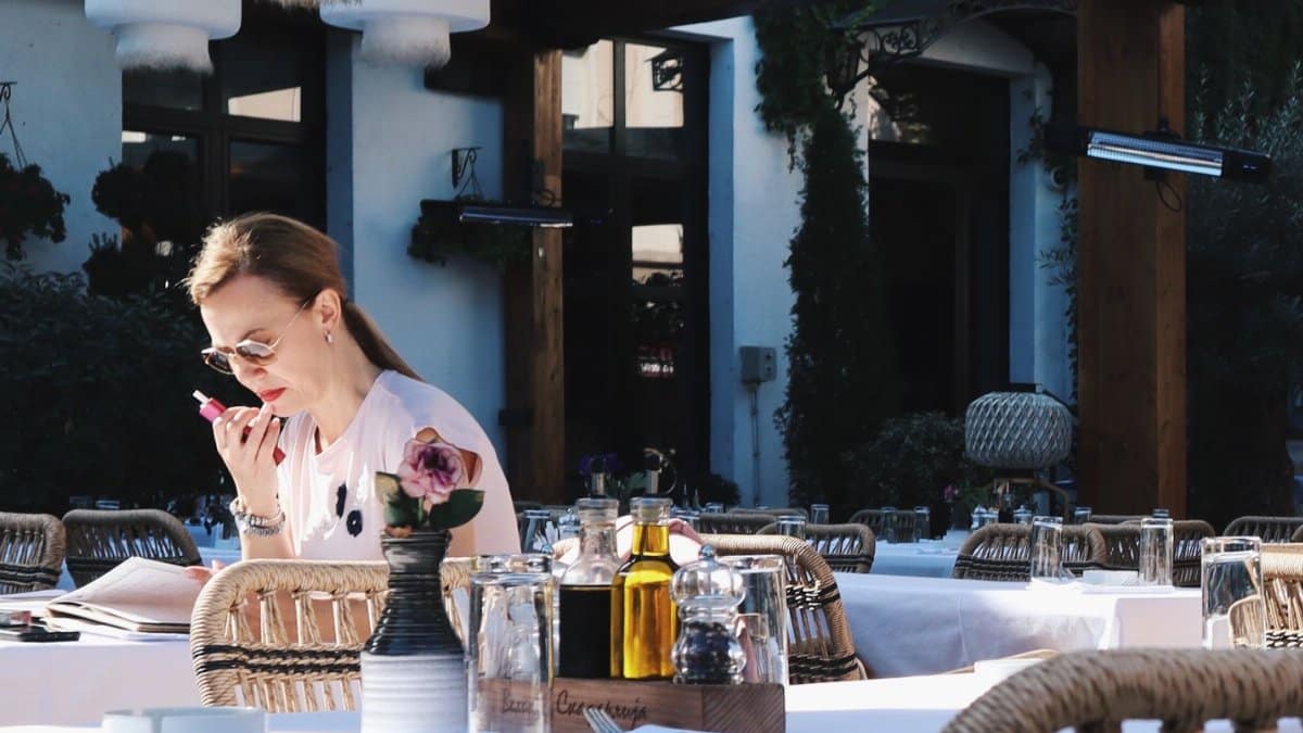 Woman enjoying leisure time in a charming outdoor café setting in Belgrade, Serbia.