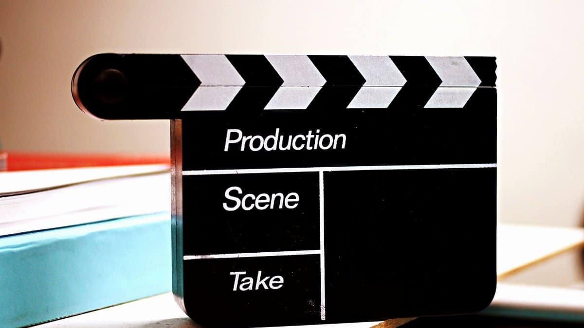 Close-up of a film clapperboard on a desk, ideal for media and production themes.
