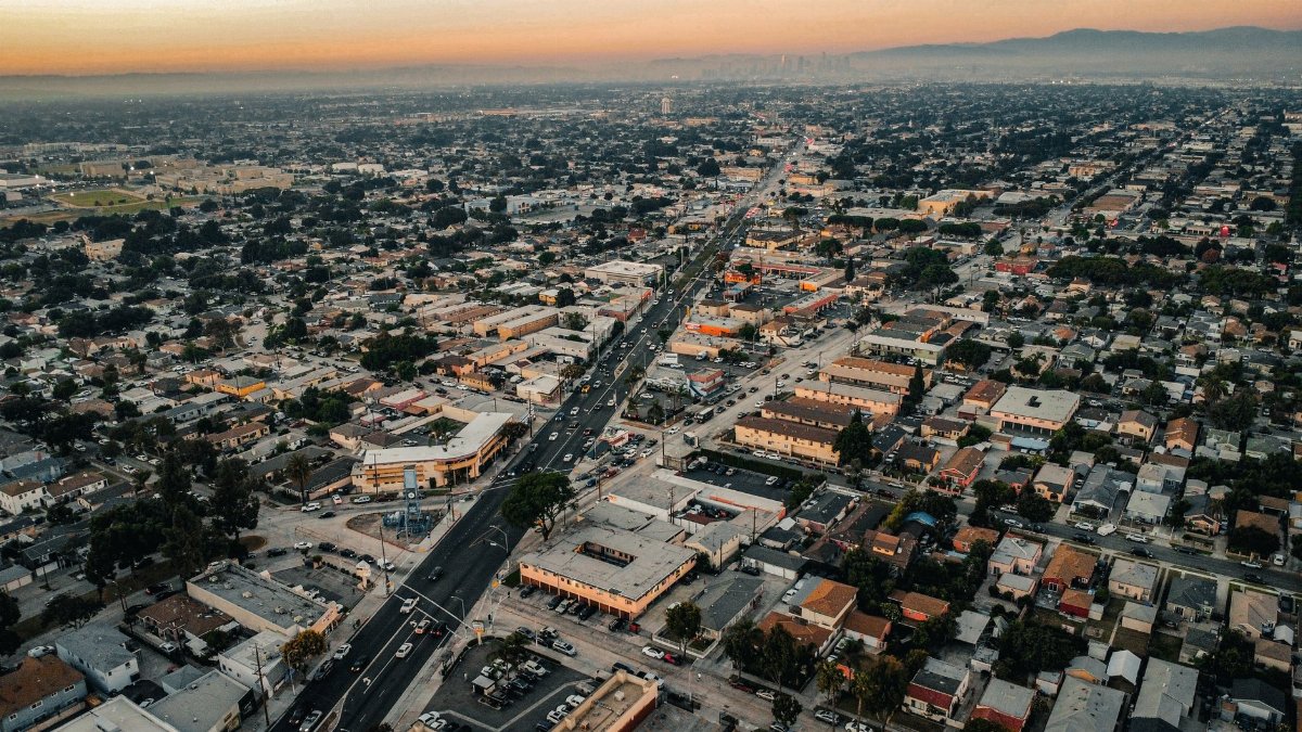 Stunning aerial view of Los Angeles showcasing urban sprawl and city skyline at sunset.