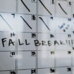Close-up of a whiteboard calendar with 'FALL BREAK' written in bold letters.