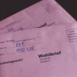 Close-up of German election ballot envelopes for the Bundestag election, showcasing voting documents.