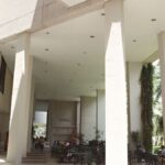 Students relax and study outdoors at a university campus in Coral Gables, Florida.