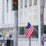American flag flutters near traffic light on Lincoln Road in Miami Beach.