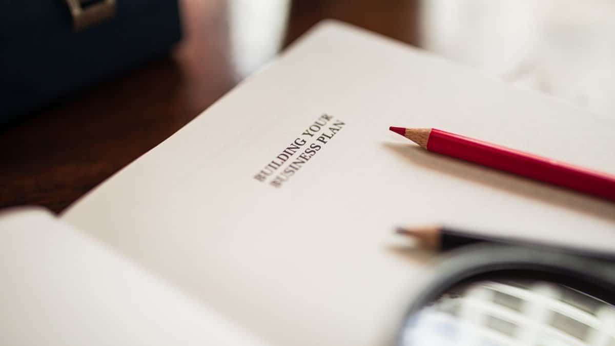 Close-up of a business plan and colored pencils on a desk.