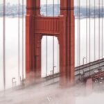Stunning view of the Golden Gate Bridge emerging through fog in San Francisco.