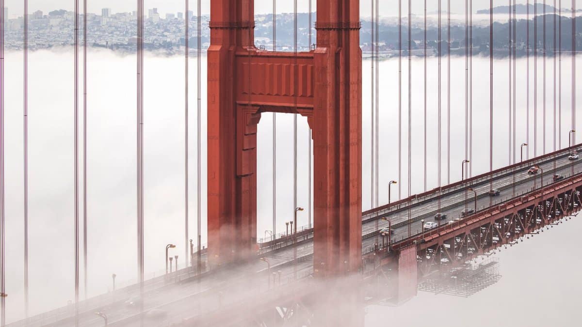 Stunning view of the Golden Gate Bridge emerging through fog in San Francisco.