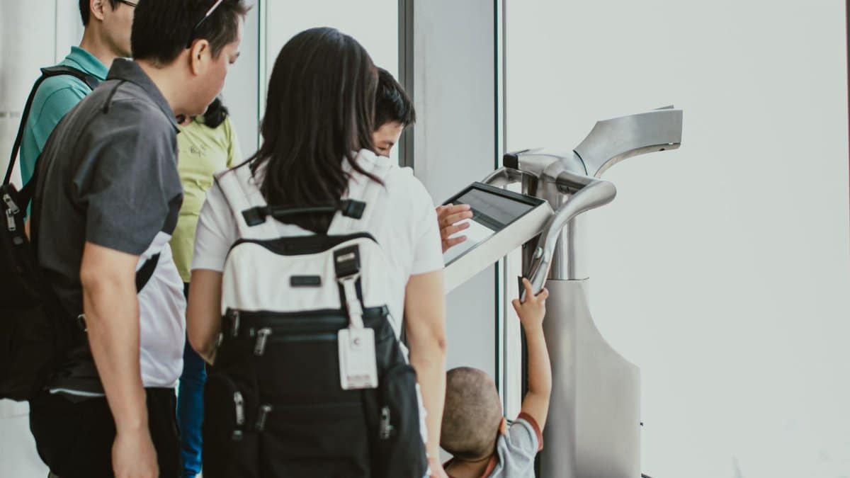 Family using digital telescope at observation deck in Dubai, UAE.