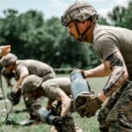 US Army soldiers engage in a rigorous outdoor training exercise at Fort Benning, demonstrating teamwork and discipline.