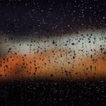 Raindrops on a window create a dramatic view of a colorful sunset in Fort Lauderdale, Florida.