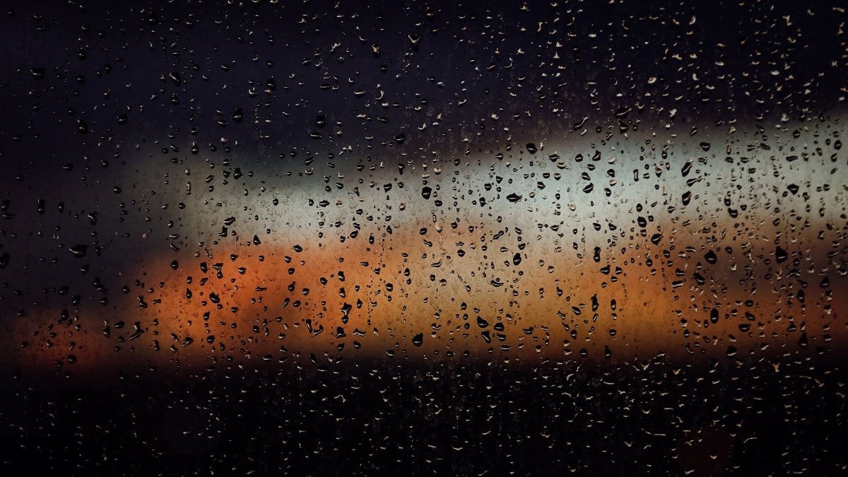 Raindrops on a window create a dramatic view of a colorful sunset in Fort Lauderdale, Florida.