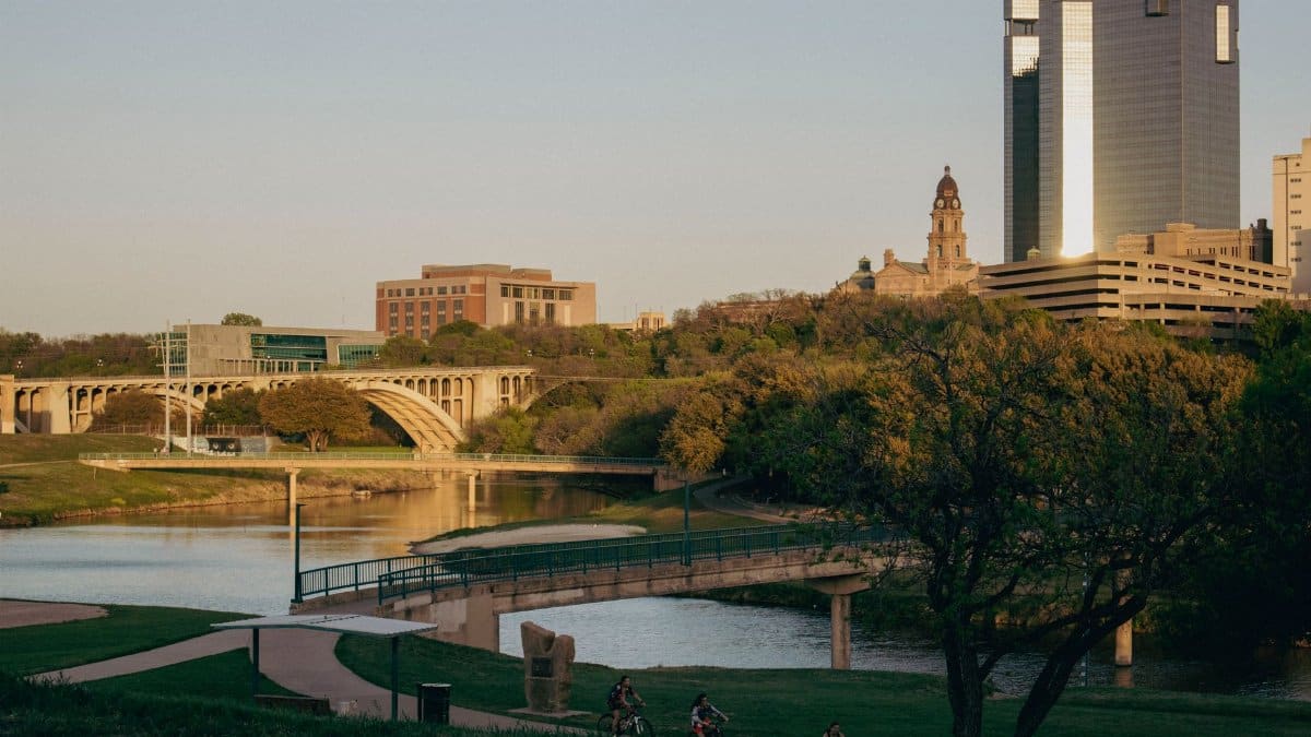 Tranquil Fort Worth skyline with bridges over Trinity River at sunset, Texas.