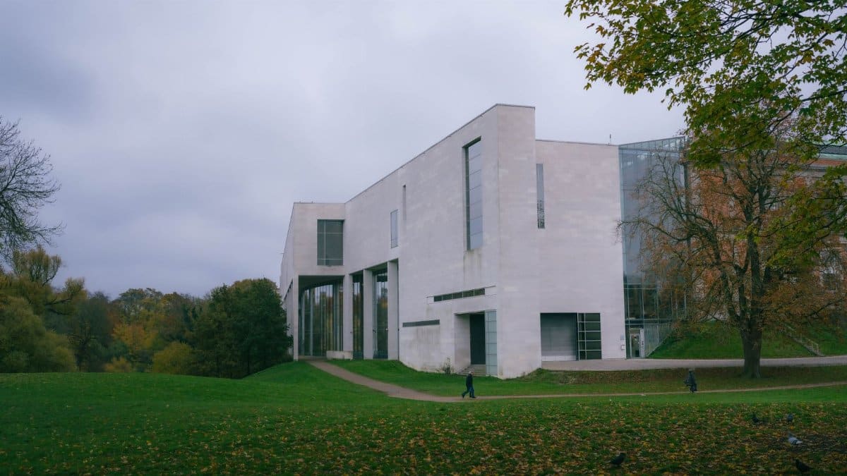 Contemporary art museum surrounded by autumn foliage and expansive green lawns.