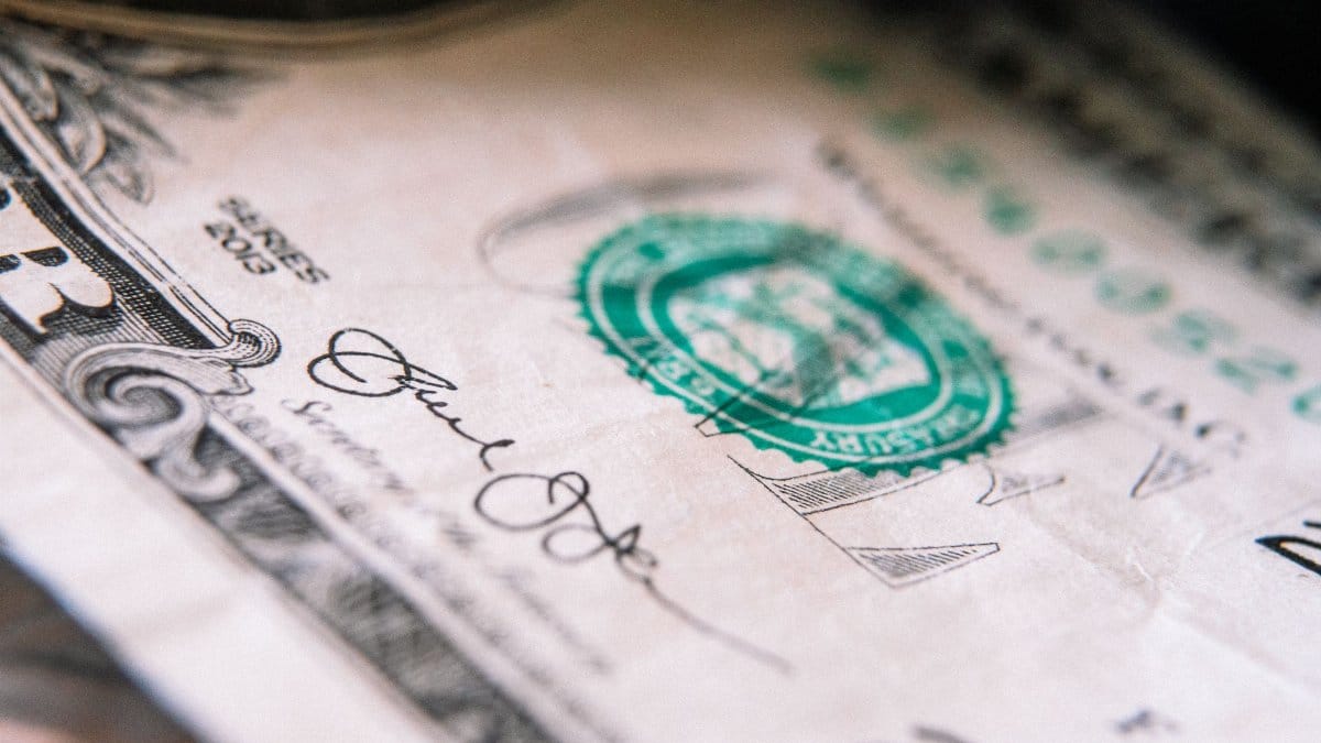 From above closeup one US dollar bill placed on table with front side up