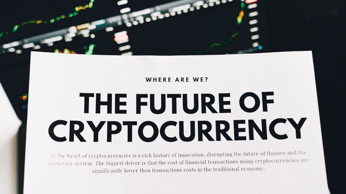 Close-up of a finance article on cryptocurrency with charts in the background.