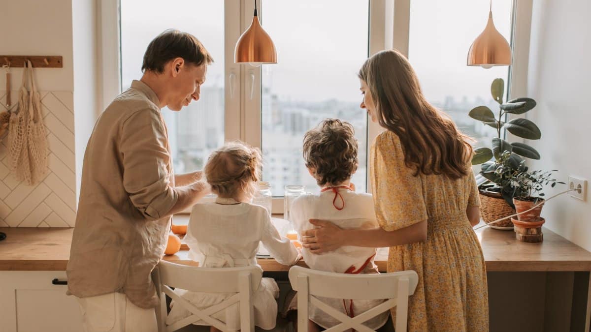 A family enjoying breakfast together in a warm sunlit kitchen, fostering togetherness.