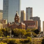 Scenic view of Dallas skyline featuring the Old Red Museum and skyscrapers.