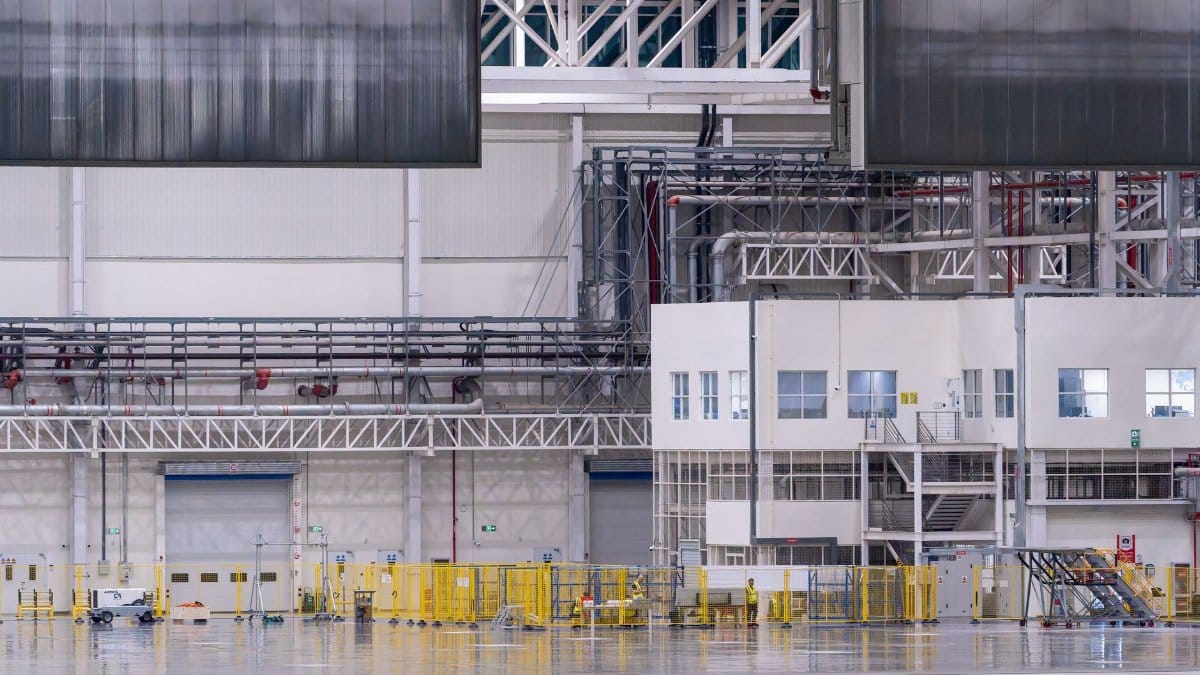 Spacious modern factory interior showcasing industrial manufacturing machinery.