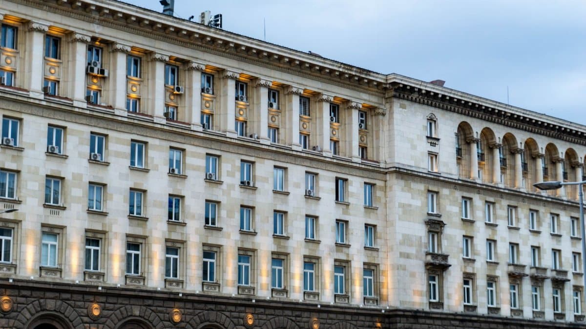 Illuminated government building in Sofia, showing classic architectural design under a twilight sky.