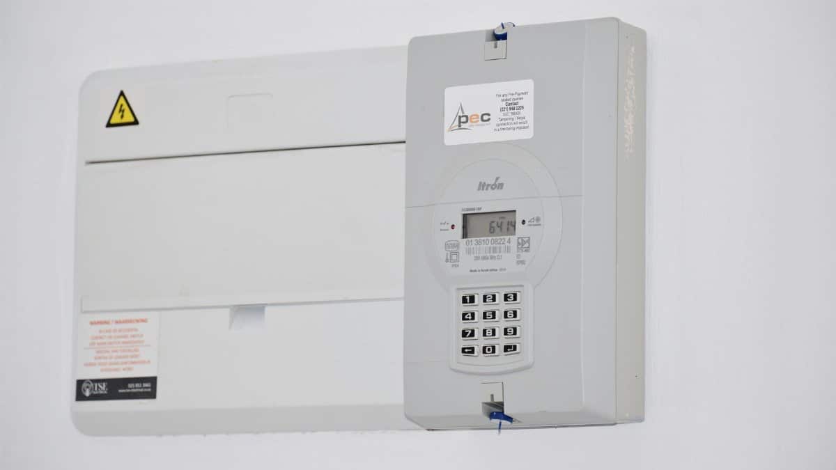 Electrical meter and fuse box on a white wall in Cape Town, South Africa, for energy monitoring or billing.