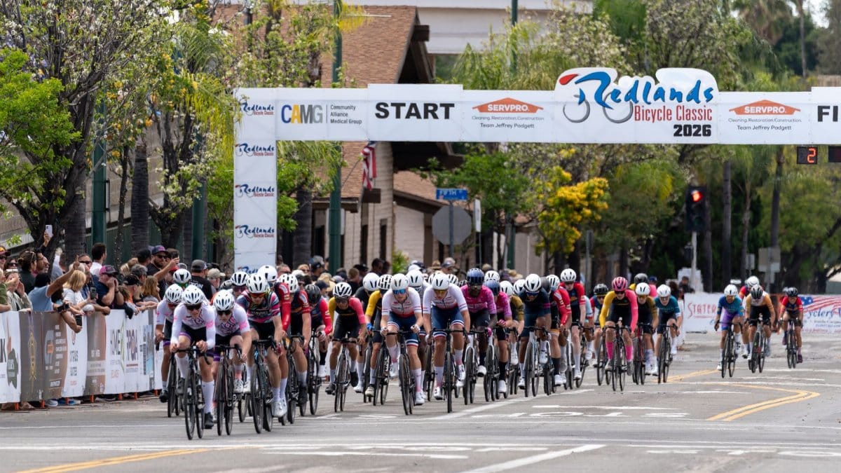 Exciting scene from the Redlands Bicycle Classic 2026, featuring a dynamic group of cyclists competing in a thrilling outdoor race.