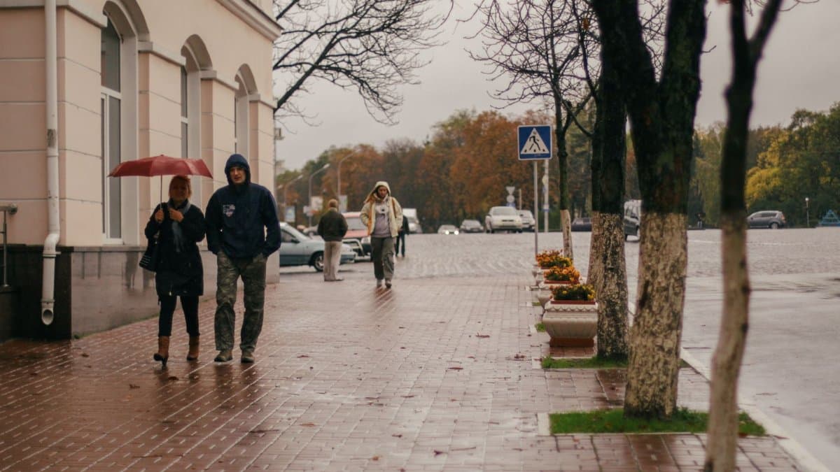 People walking with umbrellas on a rainy autumn day in Chernihiv, Ukraine.