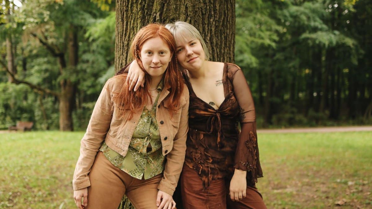 Friends enjoying a moment in a serene forest environment, embracing positivity and togetherness.