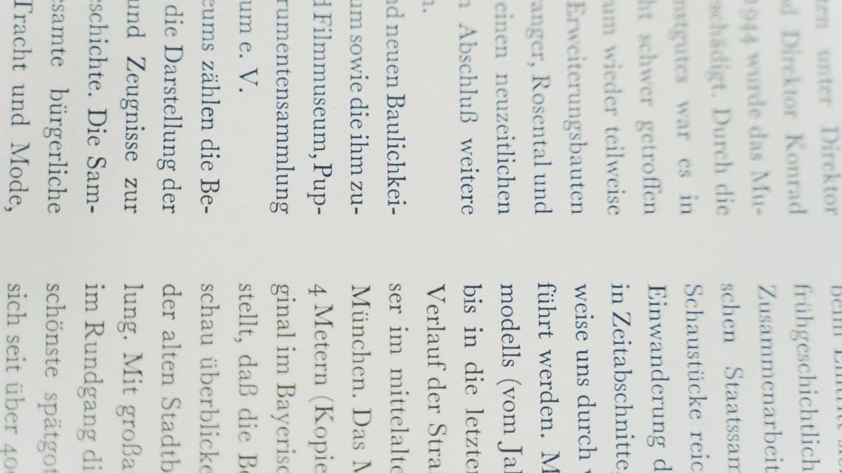 Detailed close-up of German text printed on white paper, focusing on typography.