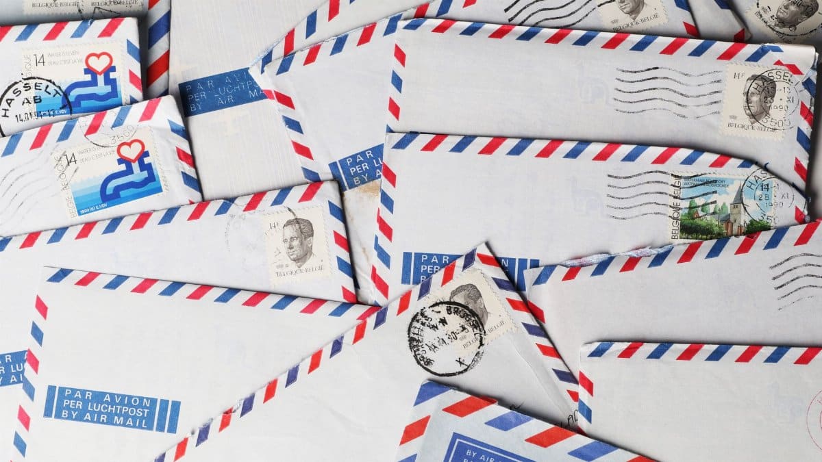 A close-up of vintage airmail envelopes with stamps and postmarks, showcasing nostalgic design.