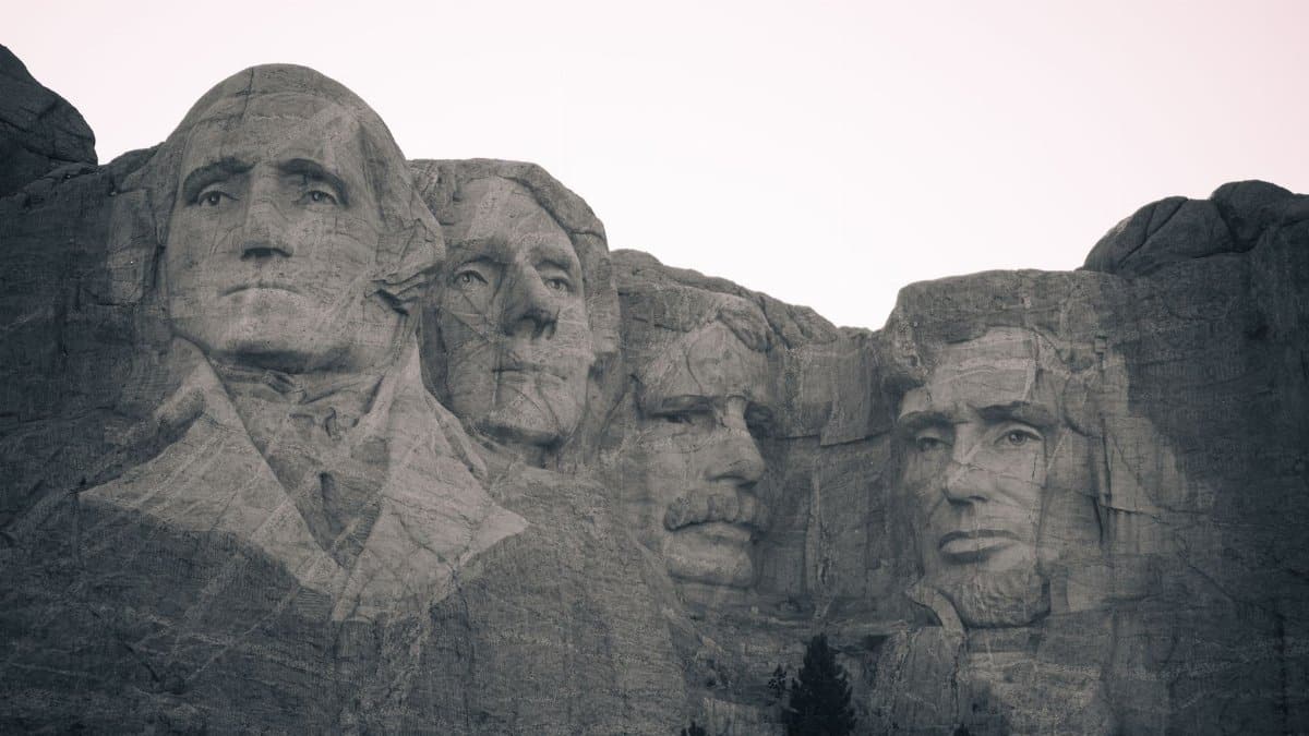 Iconic black and white view of Mount Rushmore, showcasing historical presidential carvings.