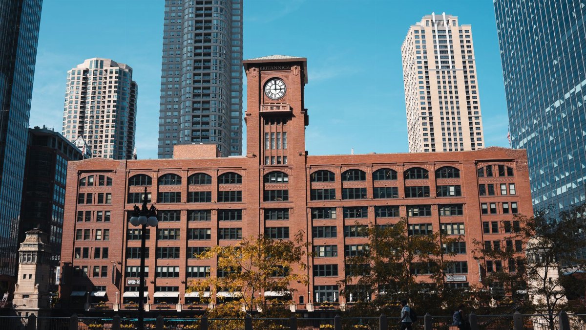 View of the historic Britannica Building against a backdrop of modern skyscrapers in downtown Chicago.