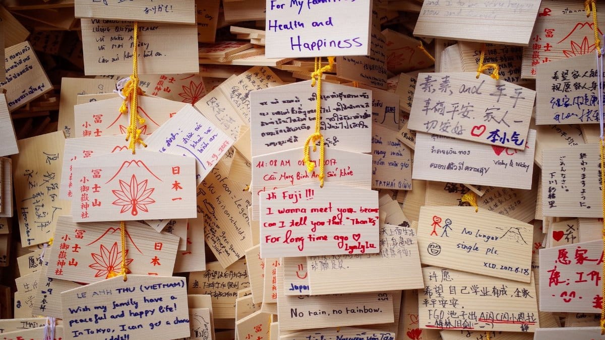 Colorful array of wish boards with handwritten messages and drawings, showcasing diverse expressions.
