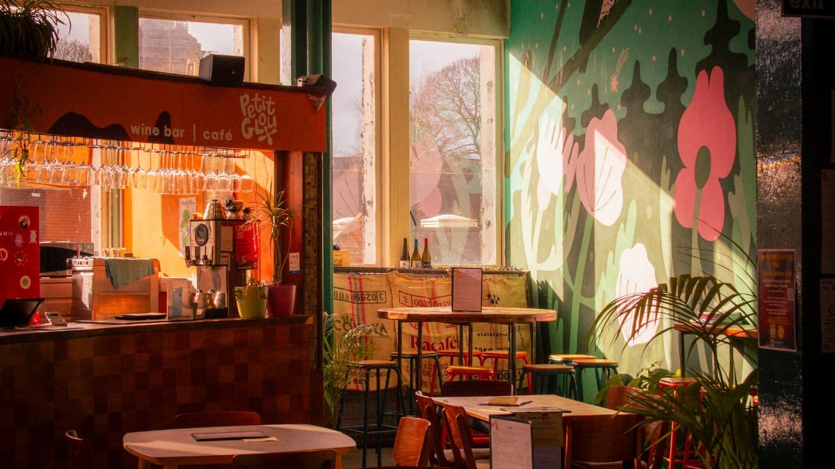 Warm and inviting wine bar café interior in Shrewsbury, England with artistic wall decor.