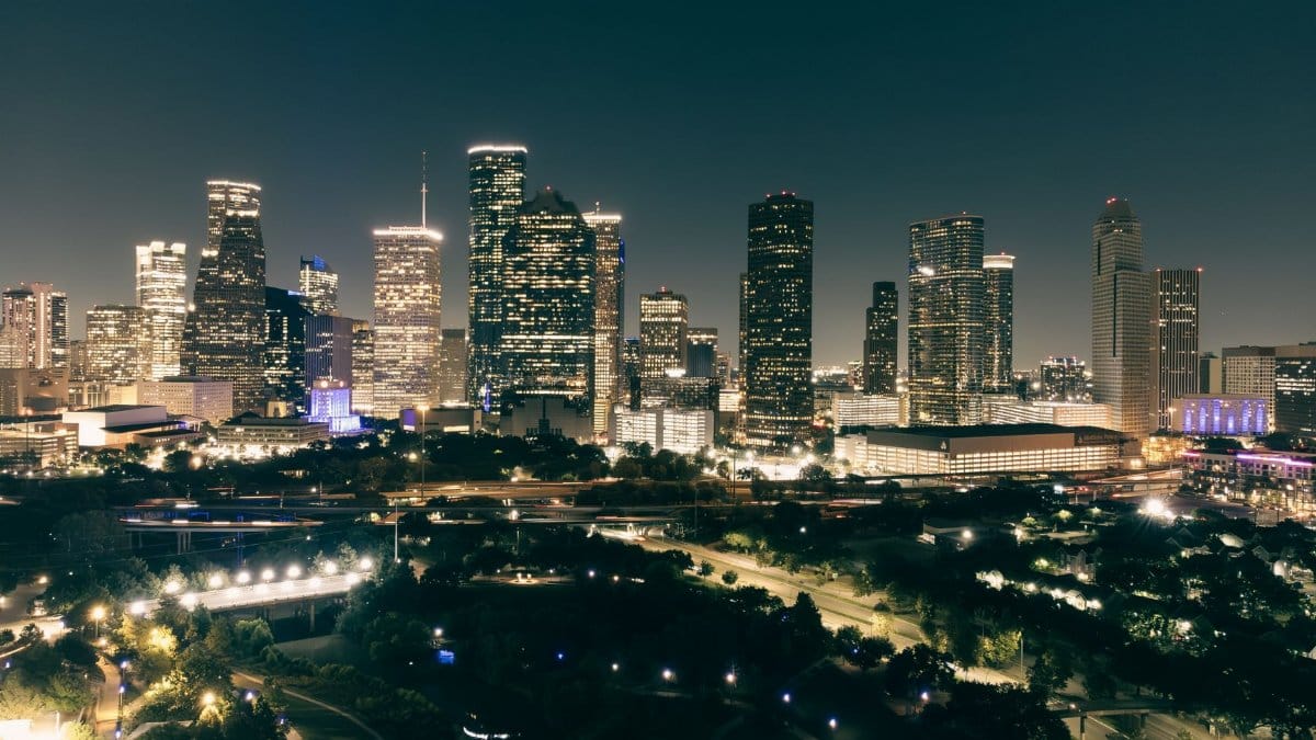 Stunning aerial view of the illuminated Houston skyline at night, showcasing urban architecture and vibrant city lights.