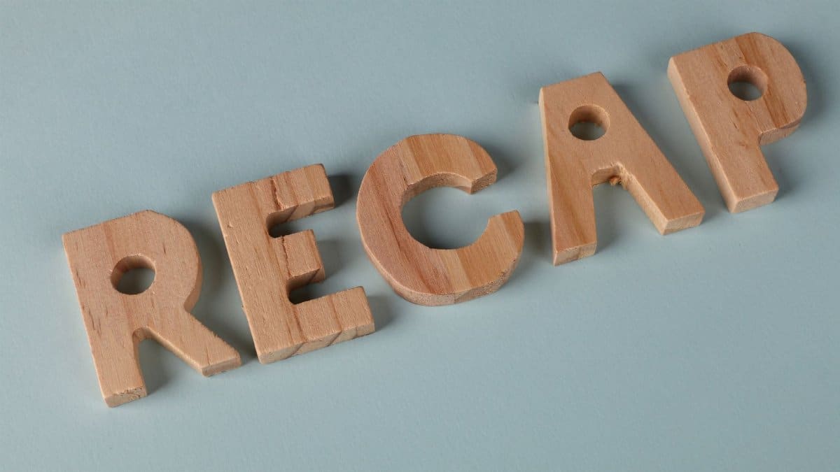 Wooden letters forming the word 'RECAP' on a soft blue background, ideal for presentations.