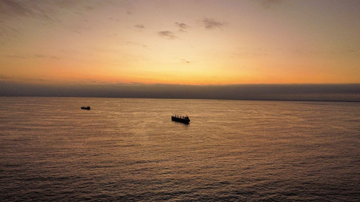 Aerial view of ships sailing on the Pacific Ocean during a beautiful sunset near Antofagasta, Chile.