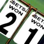 Close-up of a tennis scoreboard showing games won by each player.