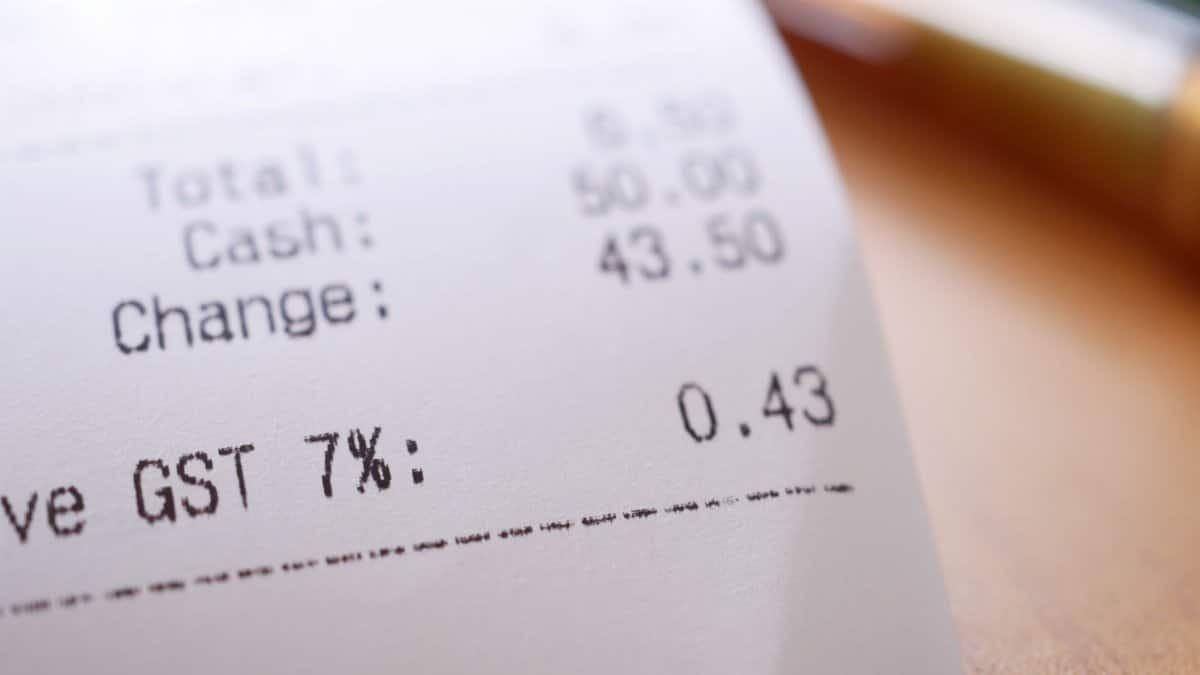 Detailed close-up image of a shopping receipt showing GST and total changes.