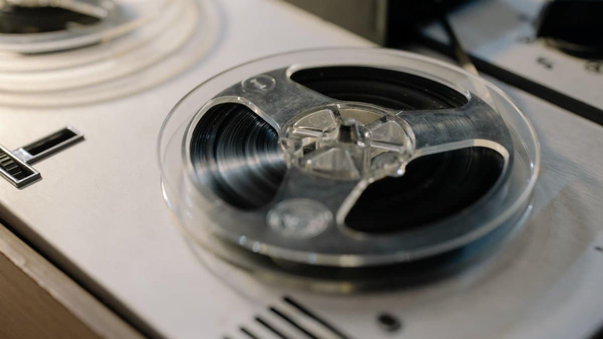 Detailed view of an analogue reel-to-reel tape recorder, showcasing retro audio technology.