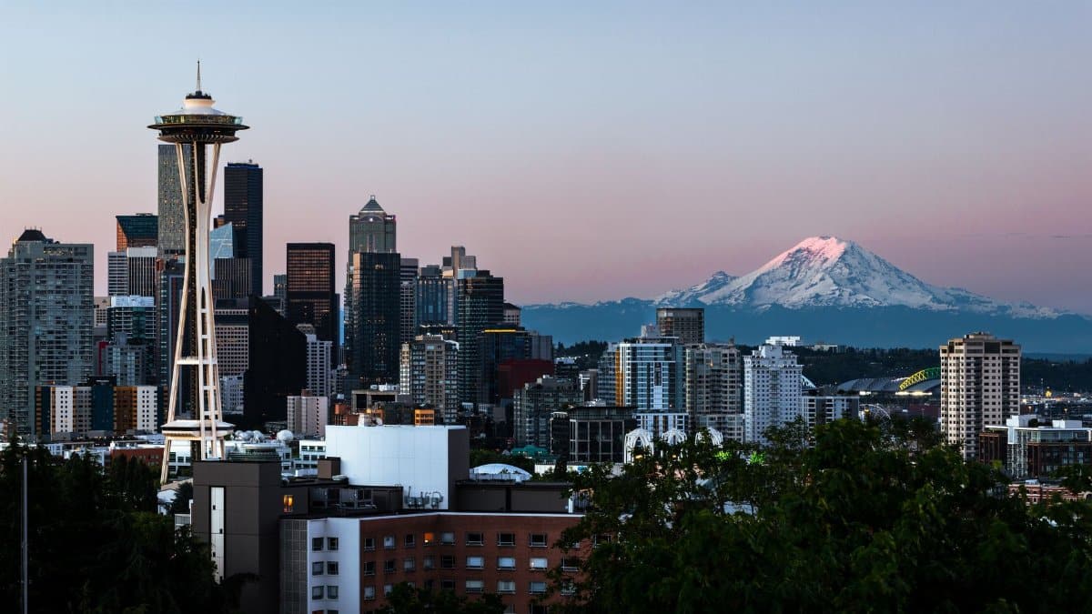 Captivating view of Seattle's skyline featuring the Space Needle and Mount Rainier at dawn.