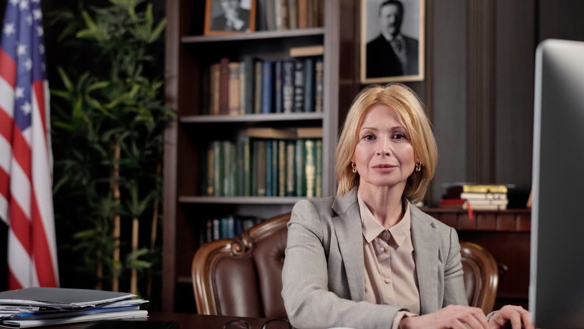 Mature businesswoman at desk in office, portraying leadership and professionalism.