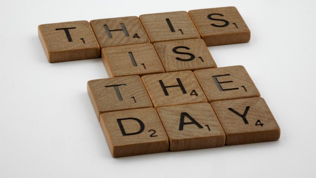 Scrabble tiles spell 'This is the Day' on a white background, inspiring change.