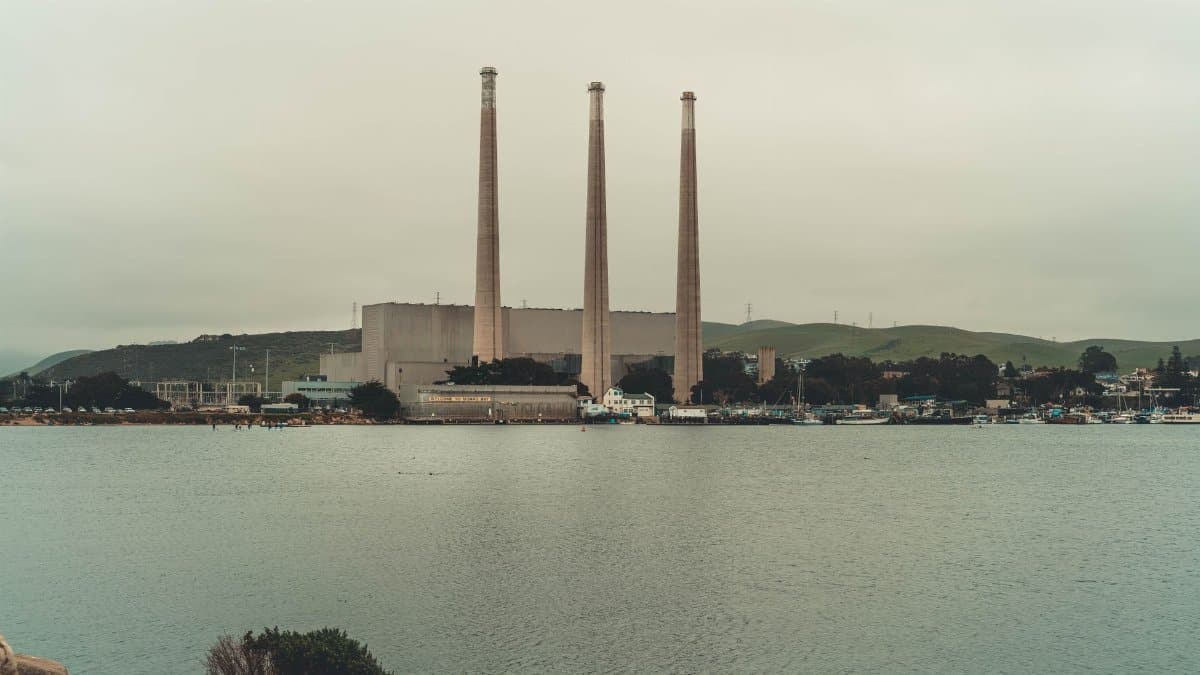 Scenic view of the Morro Bay Power Plant and water, featuring industrial architecture and nature.