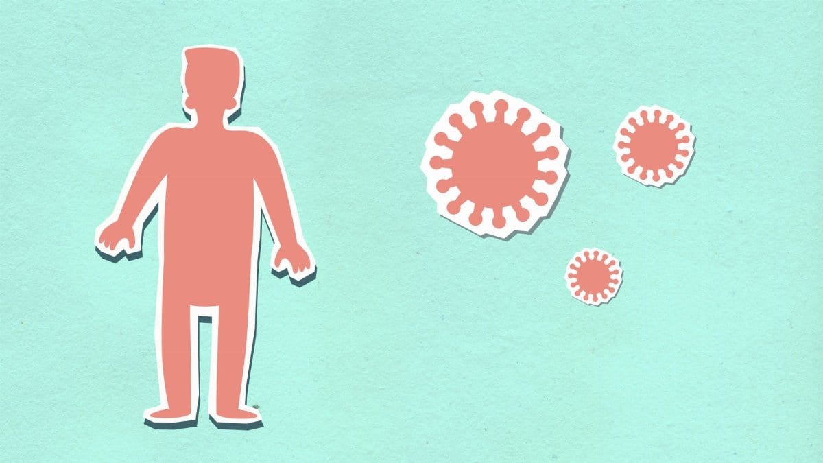 Decorative cardboard appliques of red human figure near viruses during COVID 19 pandemic on green background