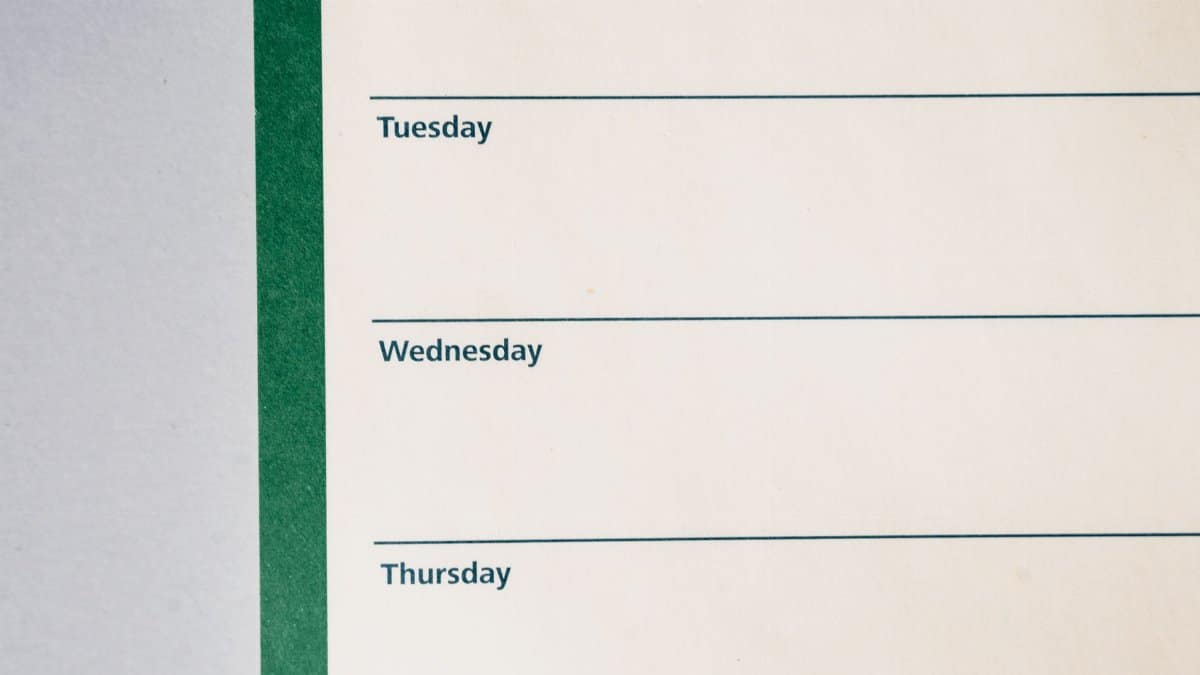 Close-up view of a minimalist weekly planner featuring days of the week.