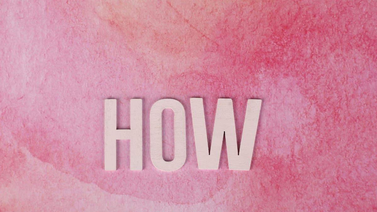 Pink watercolor background featuring the word 'HOW' in bold text for conceptual use.