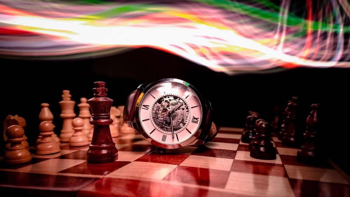 An elegant timepiece on a chessboard with dynamic light trails creating a vibrant visual effect.