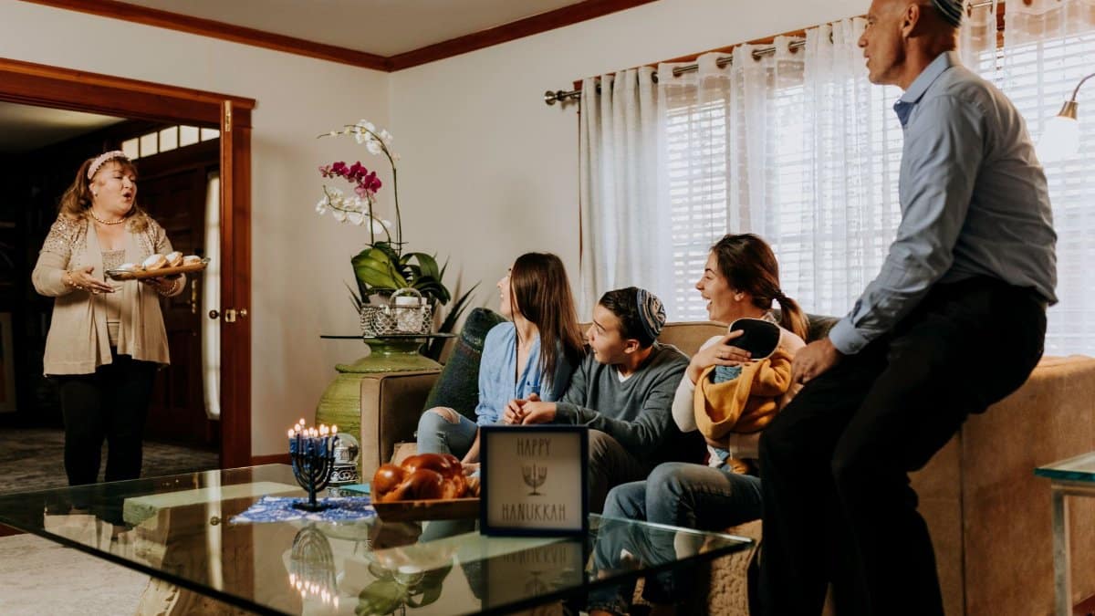 A Jewish family gathers to celebrate Hanukkah with traditional food and menorah lighting.