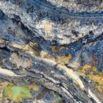 Aerial view of a quarry with excavators at work in West Java, Indonesia.